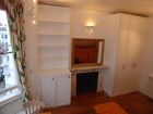 Large cupboards either side of fire place
